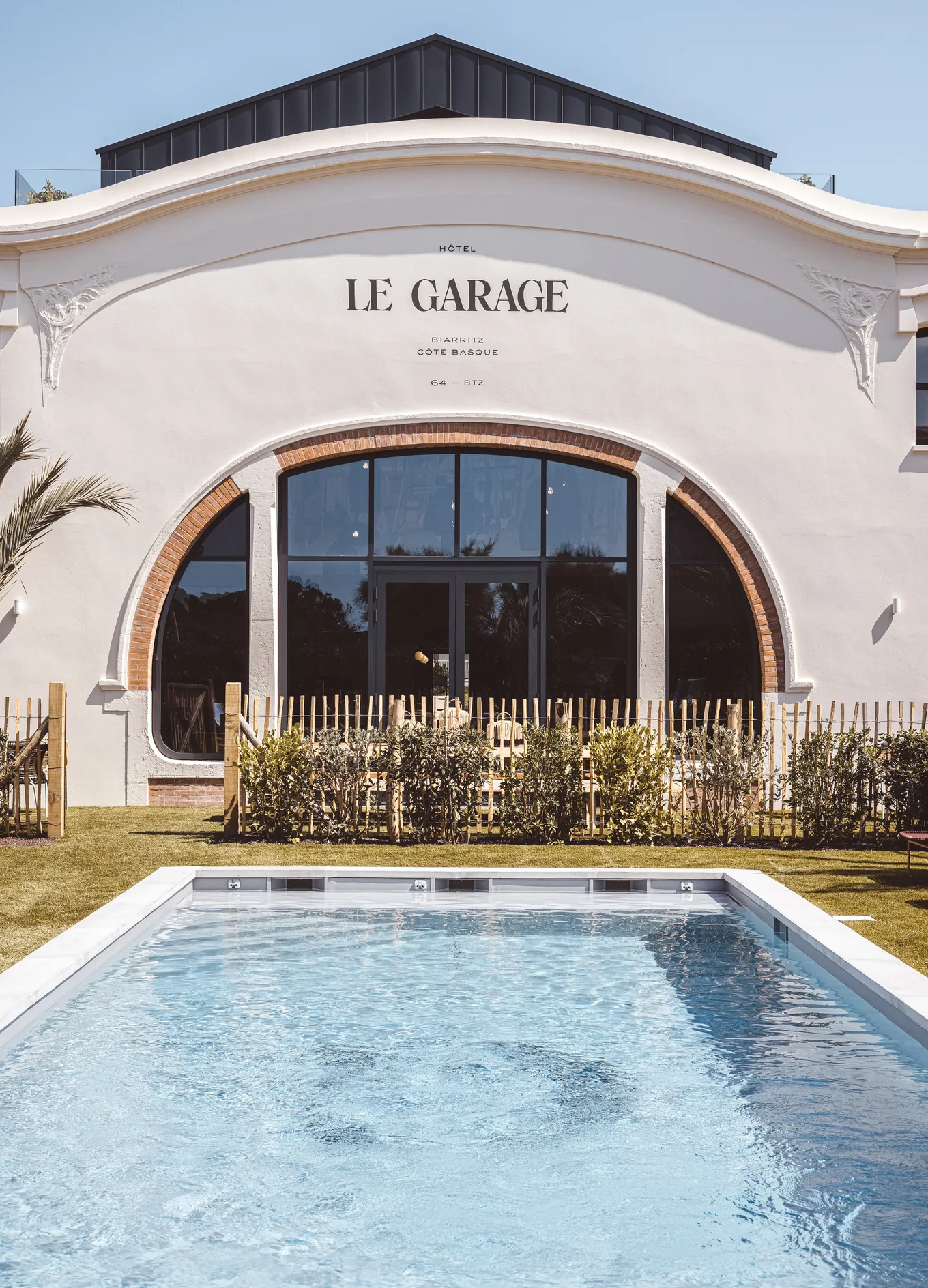 Vista sulla piscina e sulla facciata architettonica dell'Hotel Le Garage a Biarritz, Costa Basca.