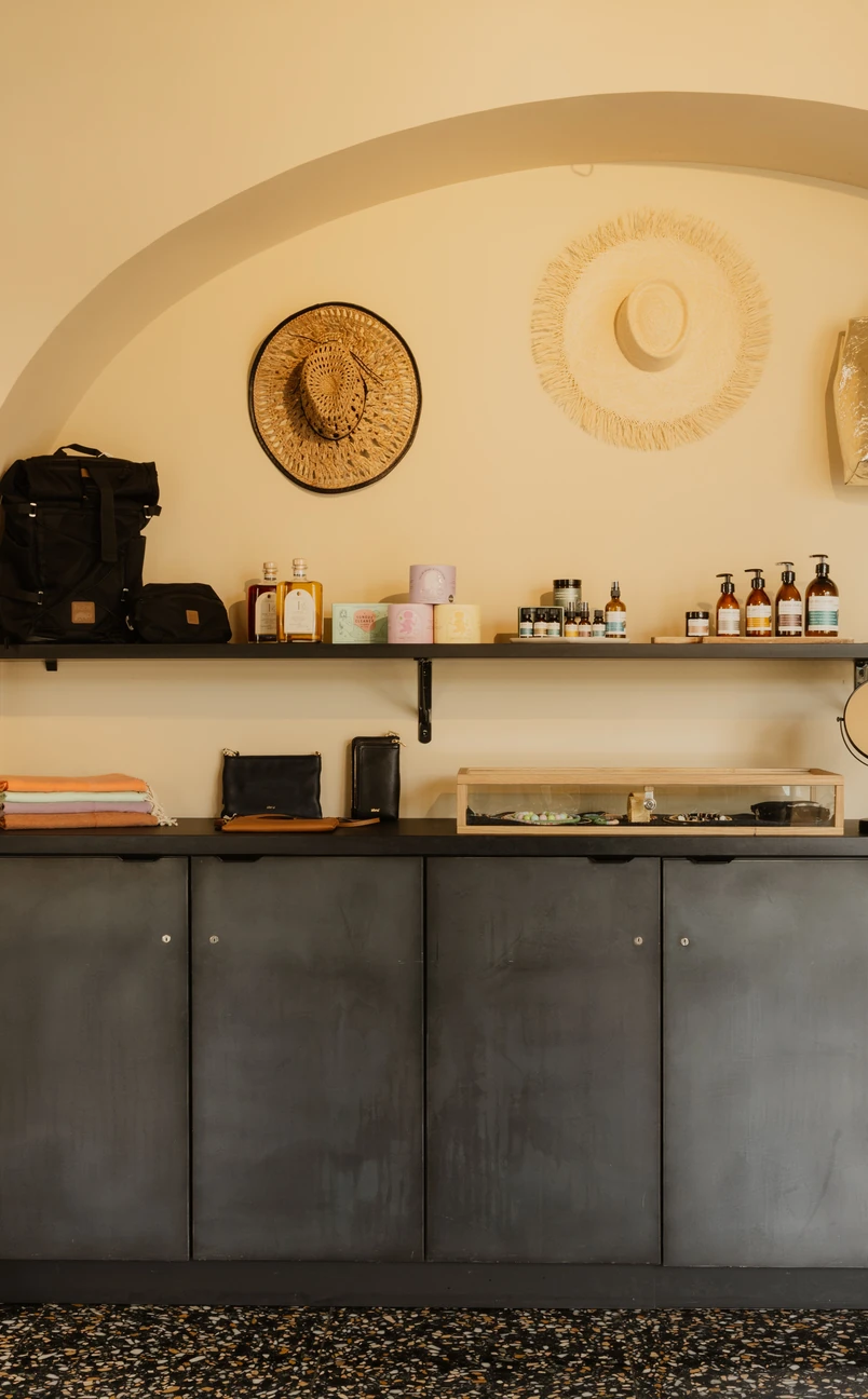 Shelves featuring curated wellness products and artisanal items in the shop at Hôtel Régina Experimental, Biarritz.