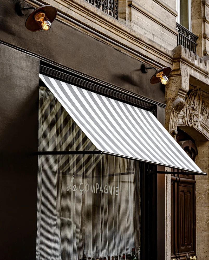 Detail of the entrance and storefront of La Compagnie bar, Experimental Group, reflecting the Parisian lifestyle.