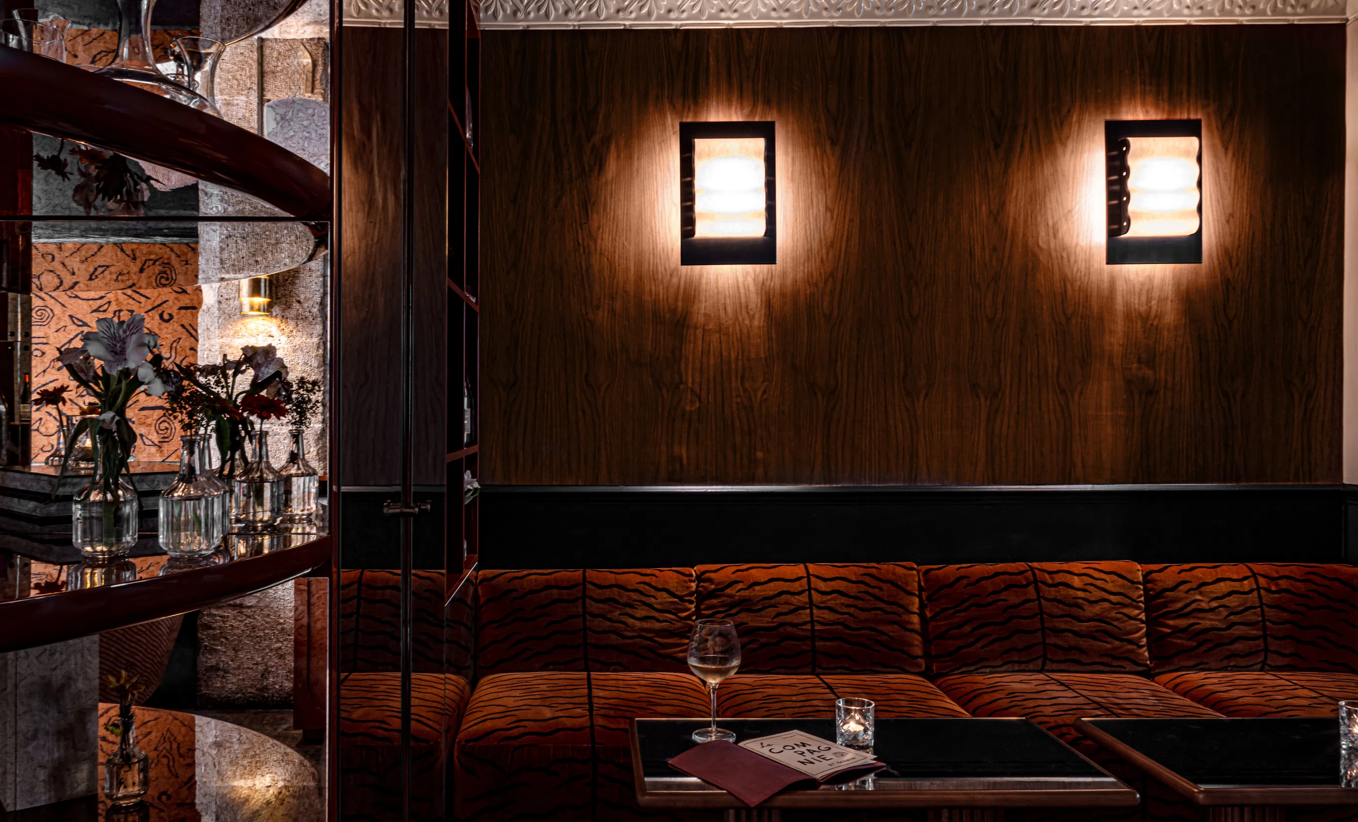 Close-up of the velvet banquette and dim lighting in the lounge of La Compagnie bar, Experimental Group.