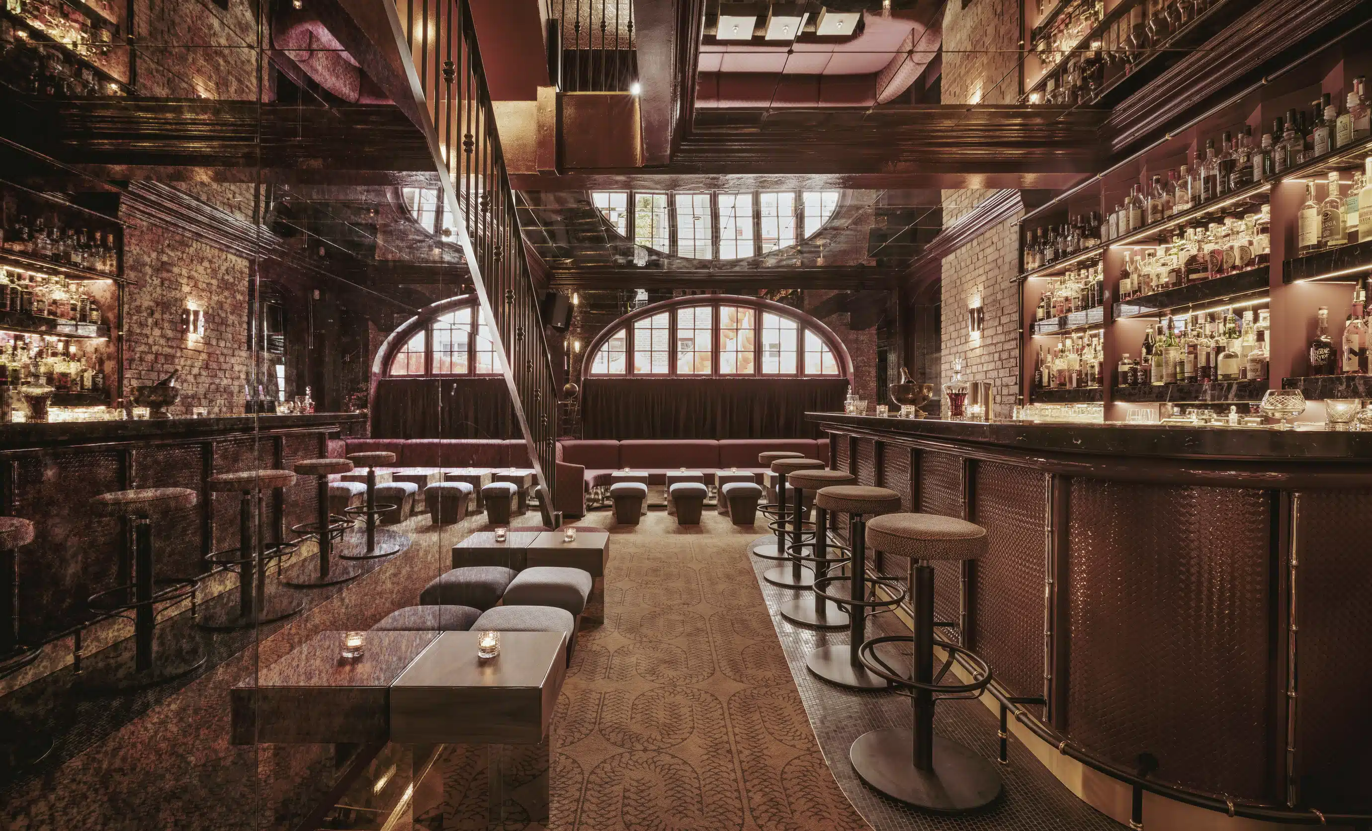 Elegant interior of a dimly lit luxury bar by Experimental Group.