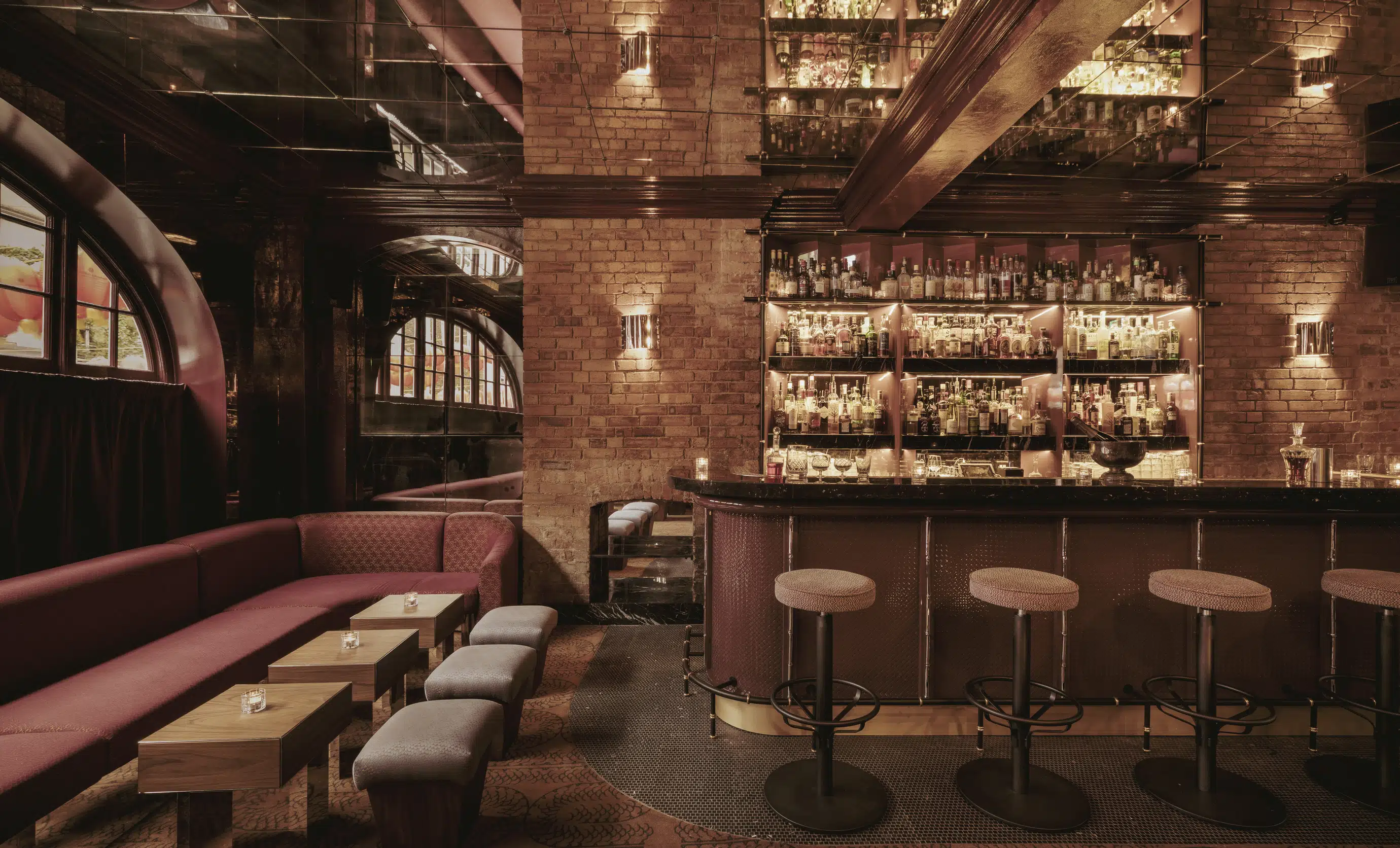 Sophisticated cocktail bar lounge area with brick walls and leather seating, Experimental Group.