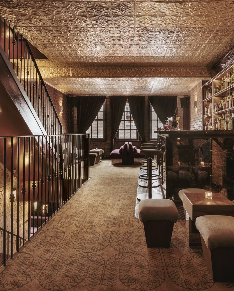 Elegant bar with marble counter, spirit shelves, and decorative gold ceiling, Experimental Group.