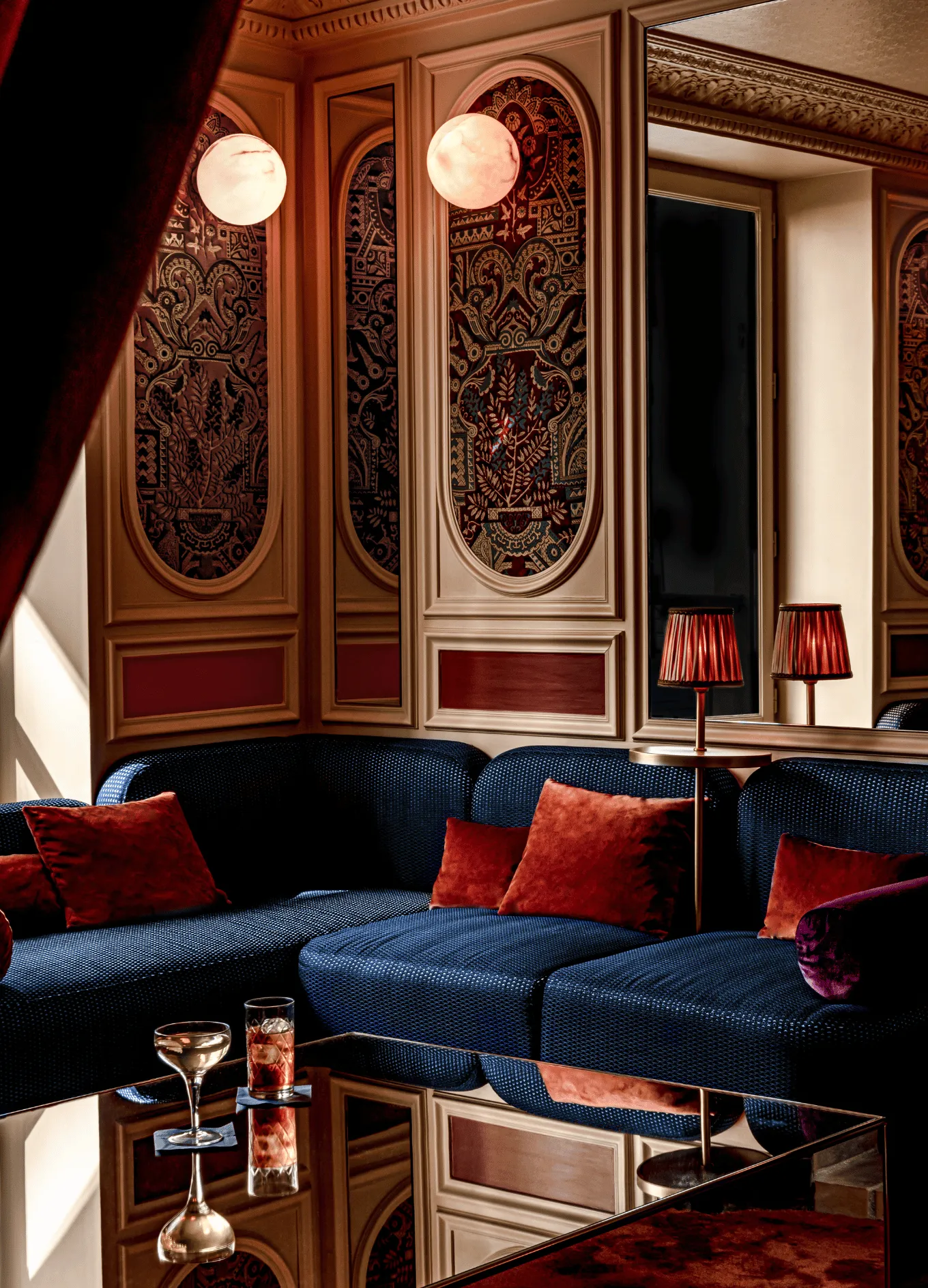 Chic lounge area with blue sofas, cocktails, and mood lighting, Experimental Group.