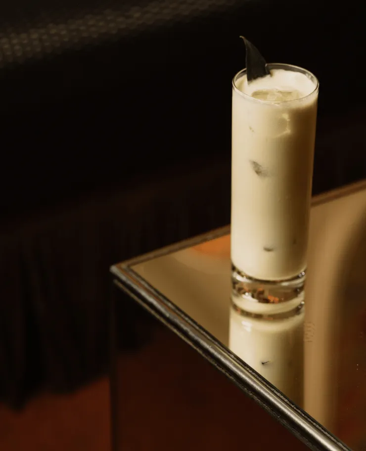 Close-up of a refreshing signature cocktail in a tall glass served at an Experimental Group bar.