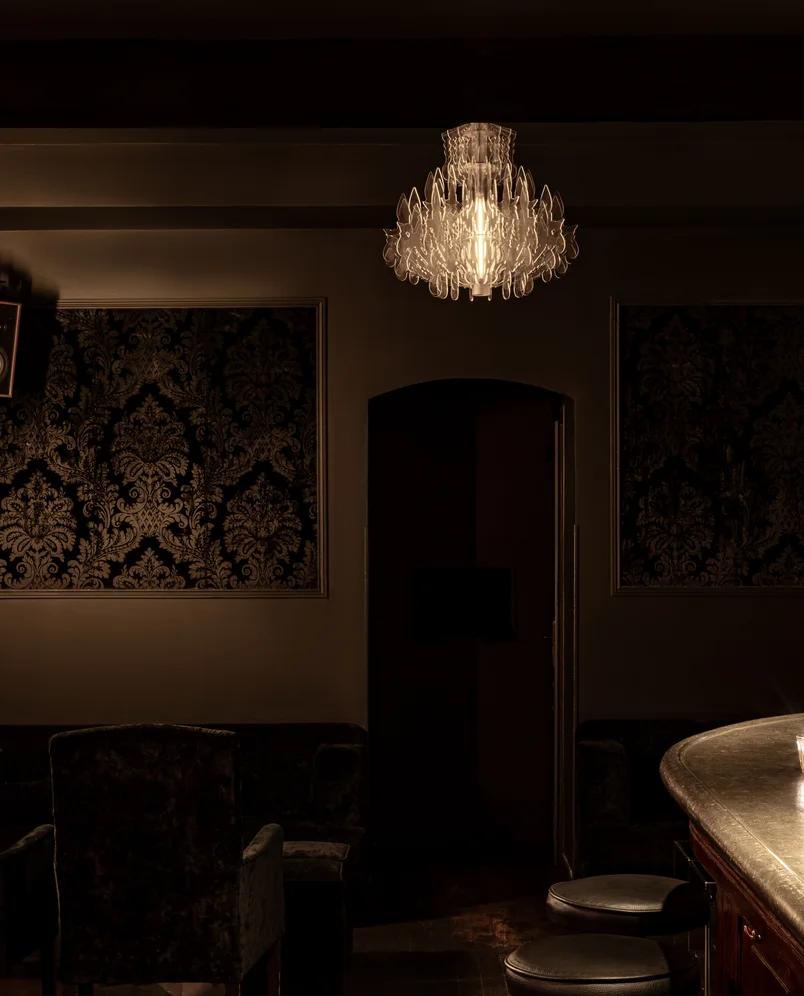 Close-up of the elegant decor and chandelier in an Experimental Group bar.