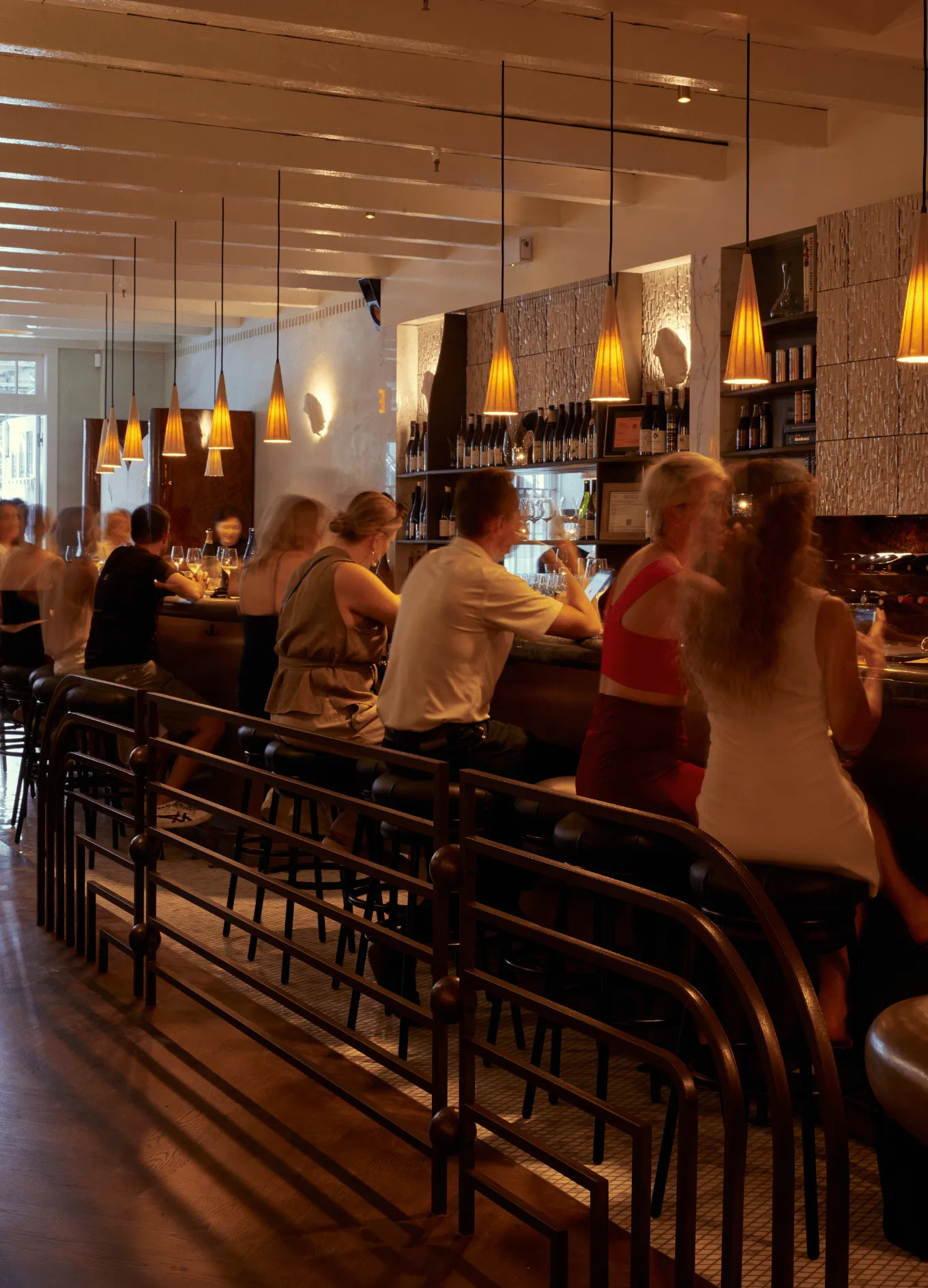 Guests enjoying the convivial atmosphere at the bar of an Experimental Group establishment.
