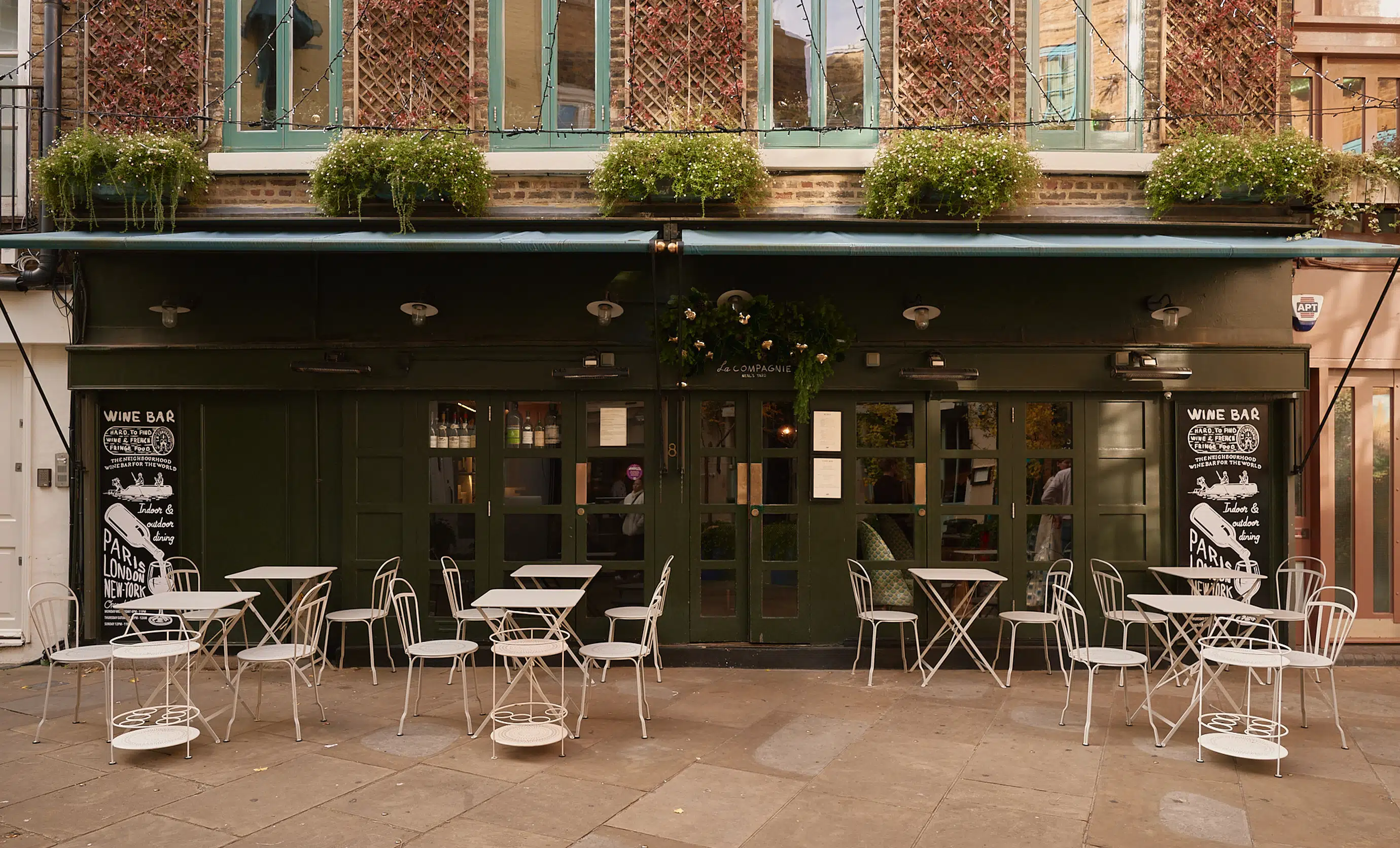 Exterior facade and outdoor terrace seating of La Compagnie des Vins Surnaturels in London, an iconic establishment by the Experimental Group.