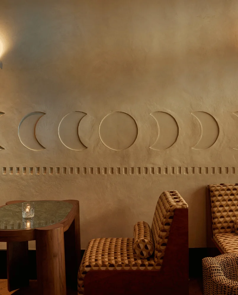 Close-up view of the minimalist moon phase wall texture at La Compagnie des Vins Surnaturels, London, part of the Experimental Group’s signature aesthetic.