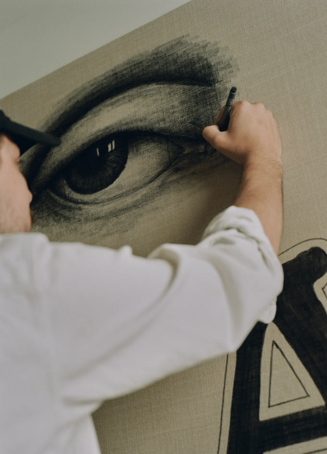 An artist hand-painting a detailed mural for the interior design of La Compagnie des Vins Surnaturels, a unique project by the Experimental Group.