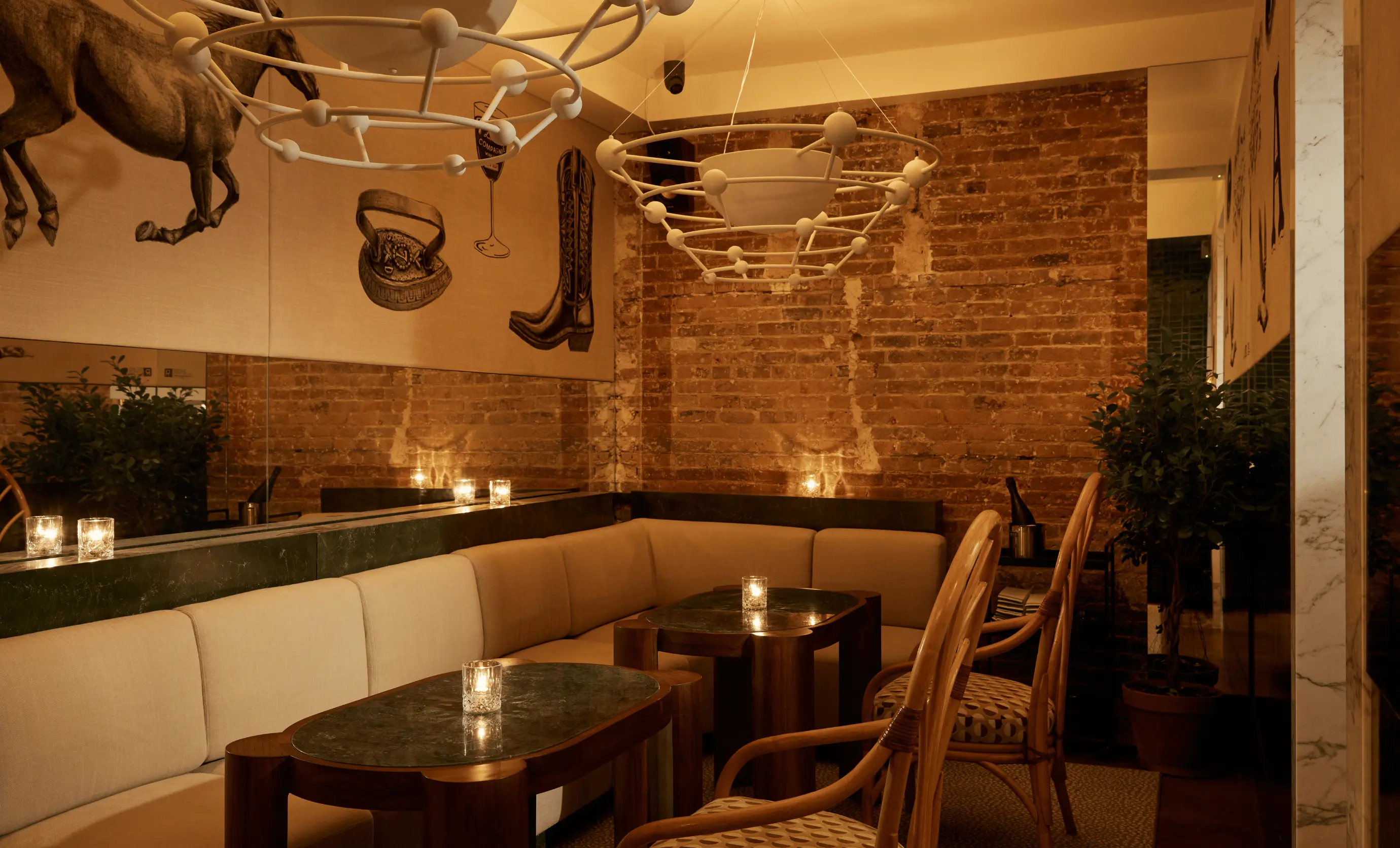 Cozy lounge seating area at La Compagnie des Vins Surnaturels, London, featuring unique wall art and refined decor by the Experimental Group.