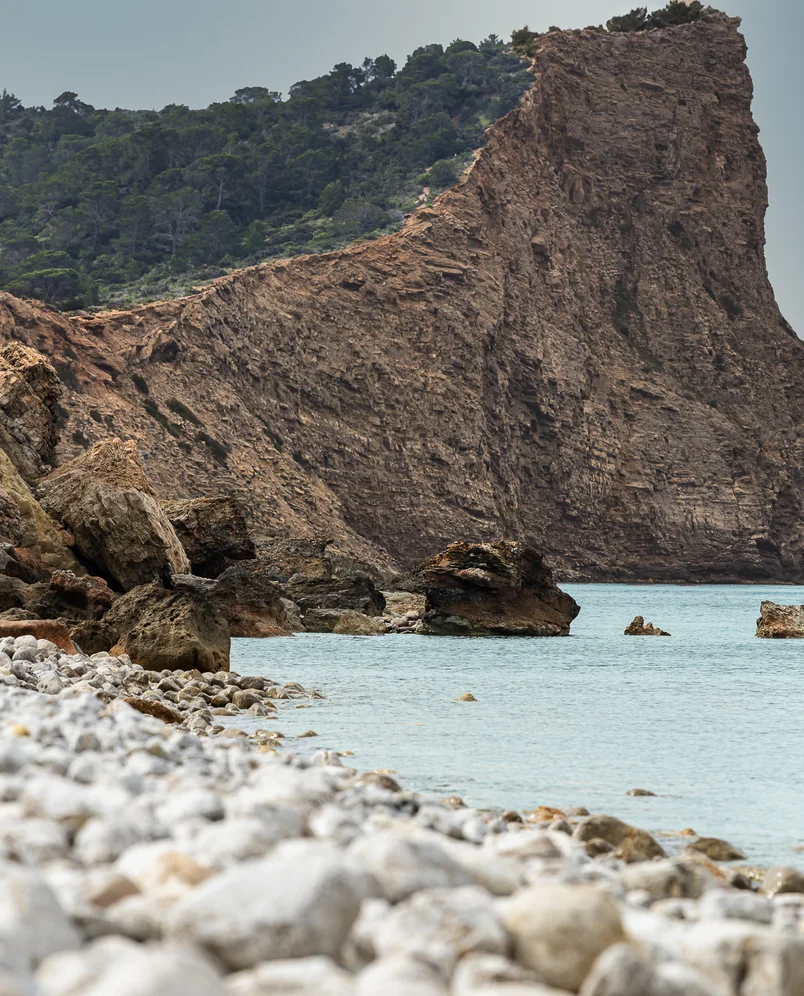 Spectacular cliffs overlooking the Mediterranean Sea on a wild beach near an Experimental Group hotel in Ibiza.