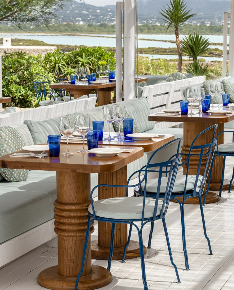Carefully set outdoor restaurant tables with a view of the natural landscape, Experimental Group, Ibiza.
