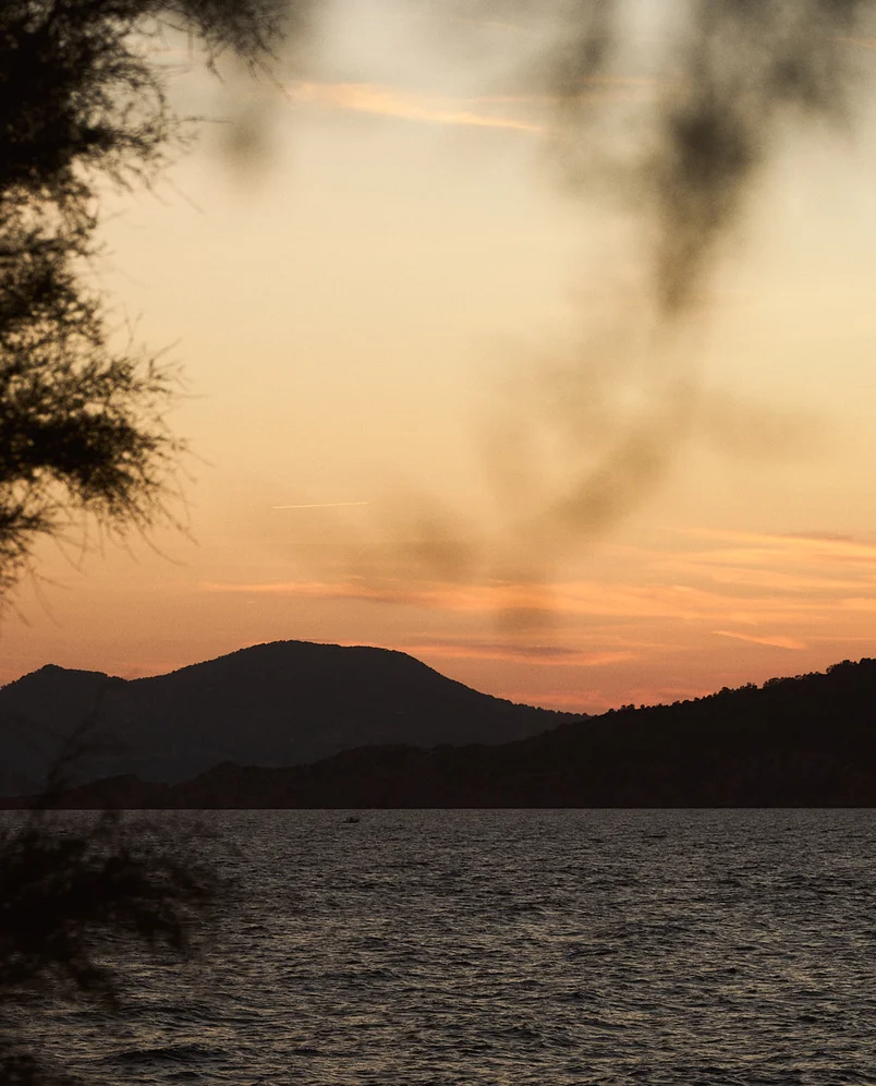 Breathtaking golden hour sunset view over the mountains and sea at an Experimental Group location.