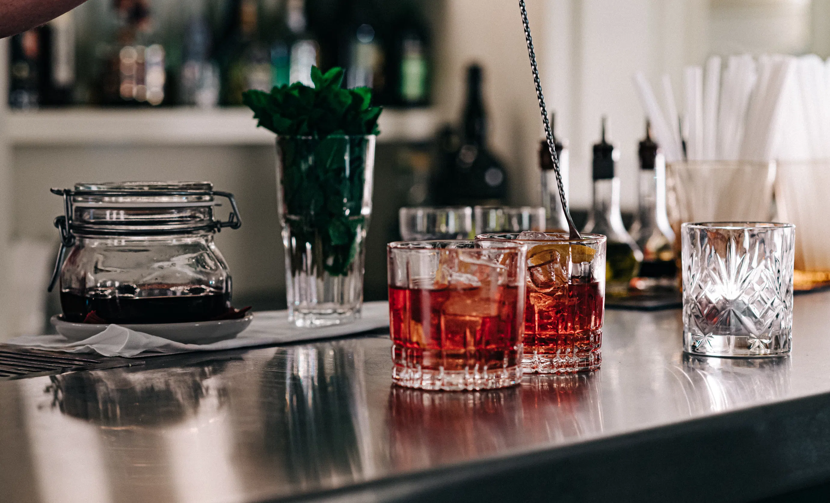 Expertly prepared cocktails served on the polished counter of the Experimental Chalet bar in Verbier.
