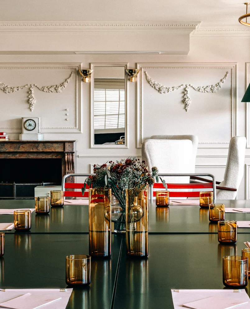 Stylish boardroom meeting table with amber glassware in a beautifully decorated room at the Experimental Cocktail Club, Verbier.