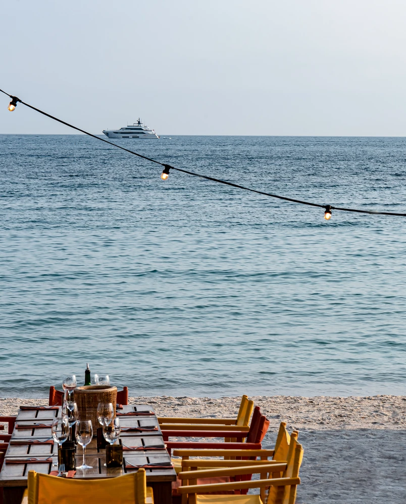 Beachside dining table with string lights, Experimental Group.