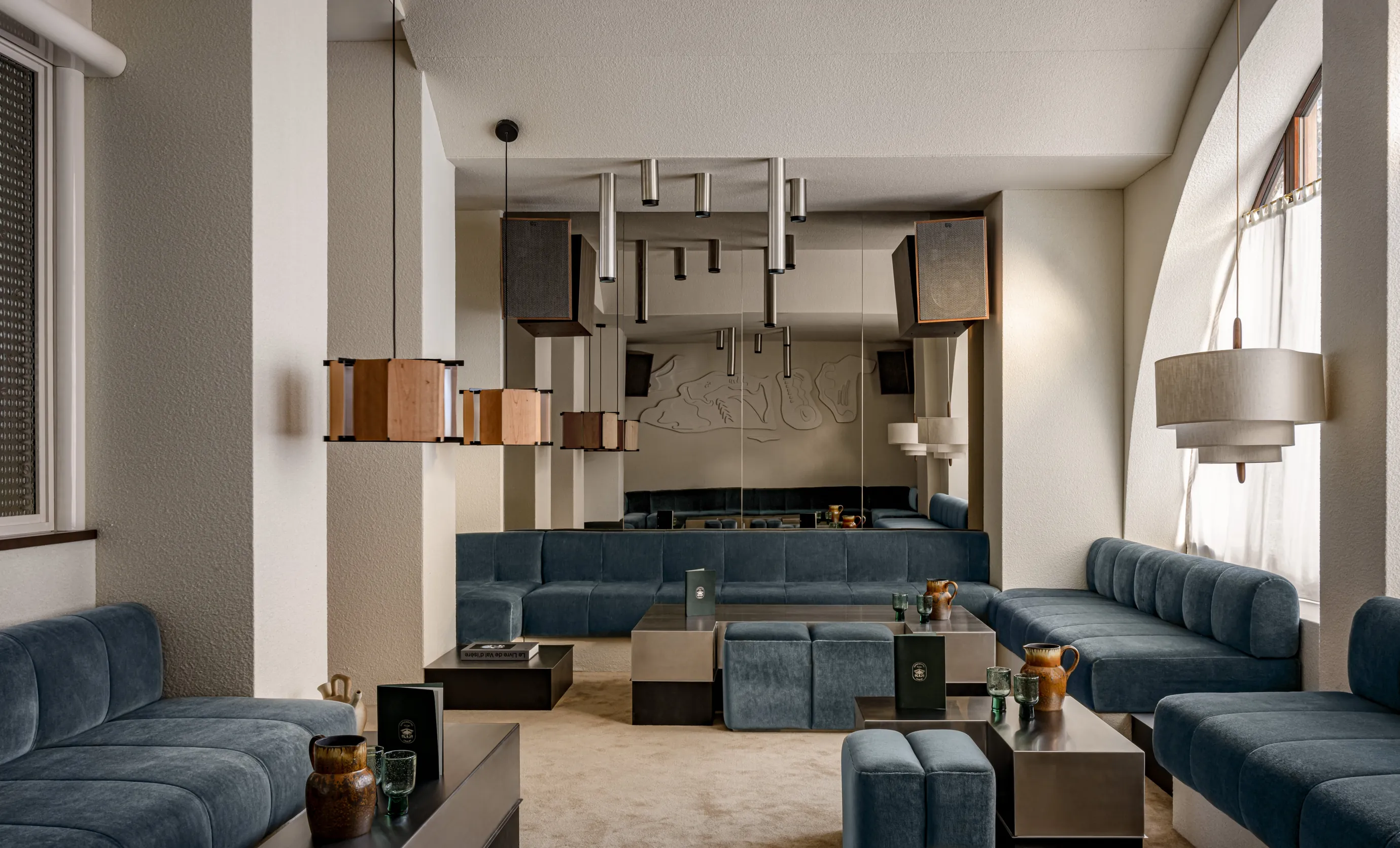 Wide view of the sophisticated lounge space at the Experimental Cocktail Club, showcasing the interior design and ambient lighting.