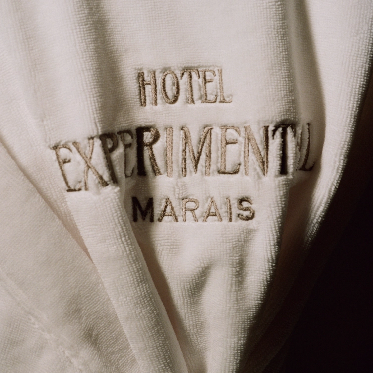 Detail of the embroidery on a white bathrobe from Hôtel Experimental Marais, Paris.