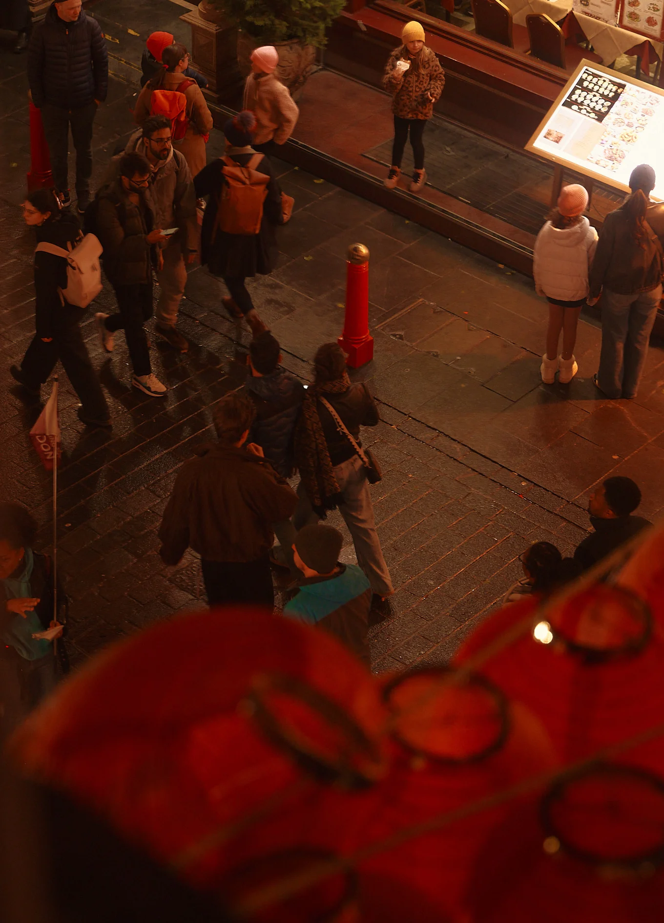 Overhead view of a bustling street from an Experimental Group establishment, urban lifestyle spirit.
