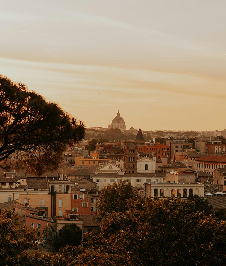 Panoramic sunset view over the rooftops of Rome, Italy.