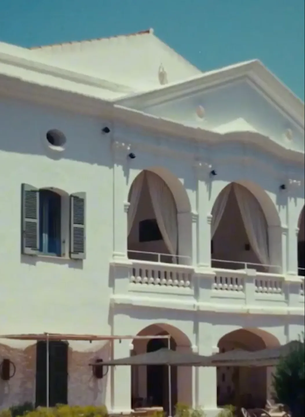 Sunny facade and classic architecture of the Experimental Beach hotel in Ibiza.