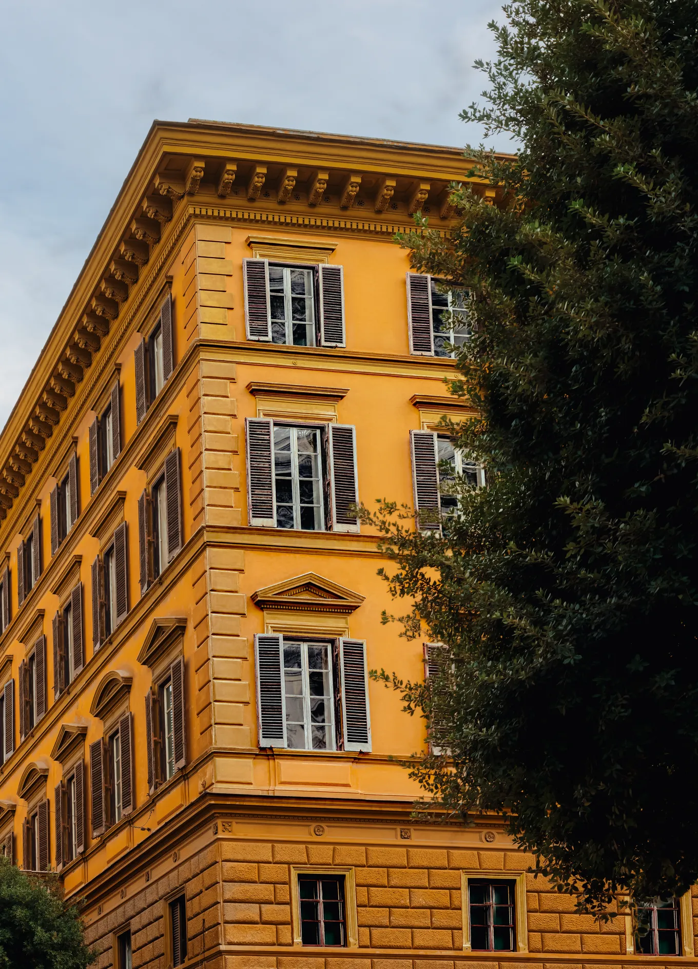 Classic yellow facade with green shutters of a historic building at Il Palazzo Experimental, Rome, Experimental Group.