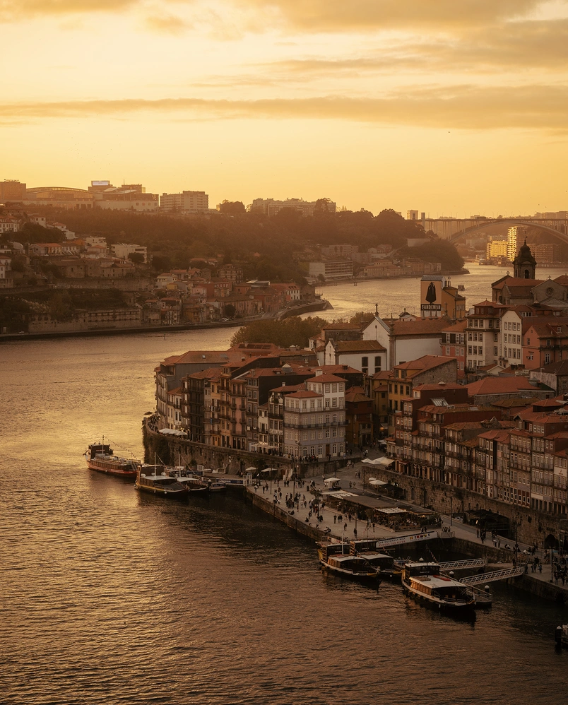 Urban landscape and sunset reflections on the river in Porto, a lifestyle destination by Experimental Group.