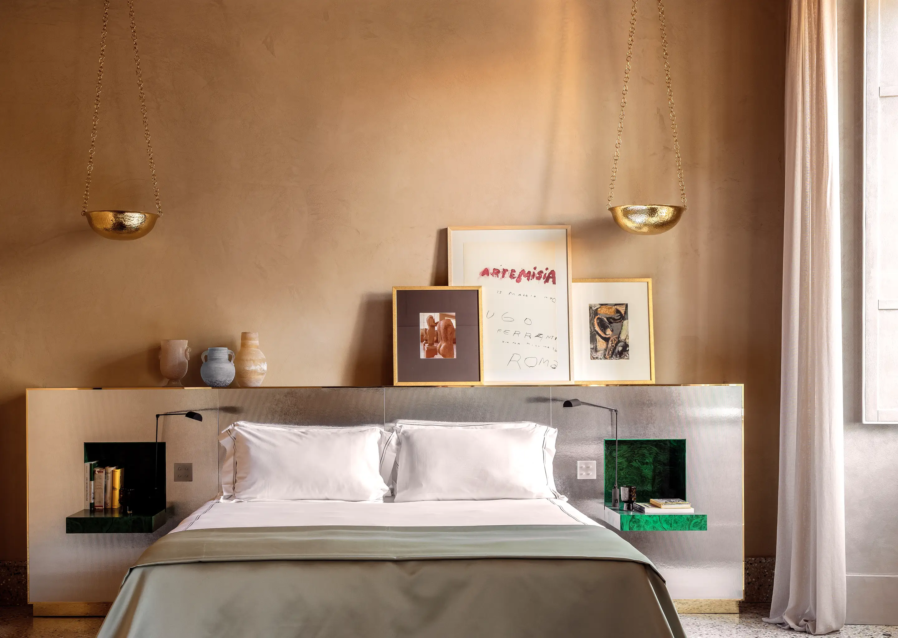 Warm ambiance of a suite decorated with artistic touches at Palazzo Experimental, Venice.