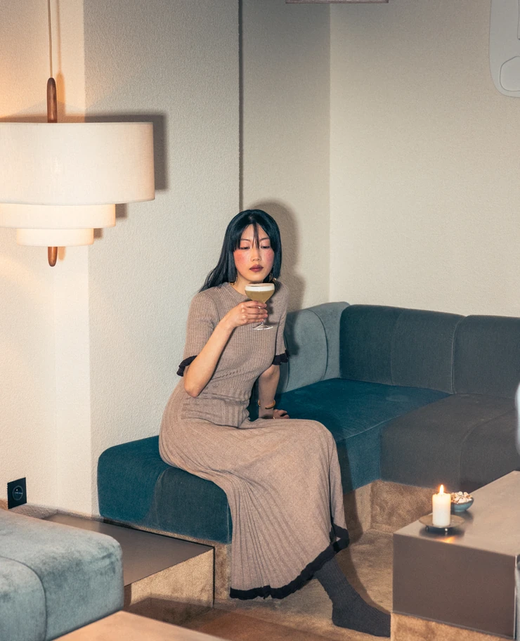 Lounge setting with a woman holding a cocktail, Experimental Group.