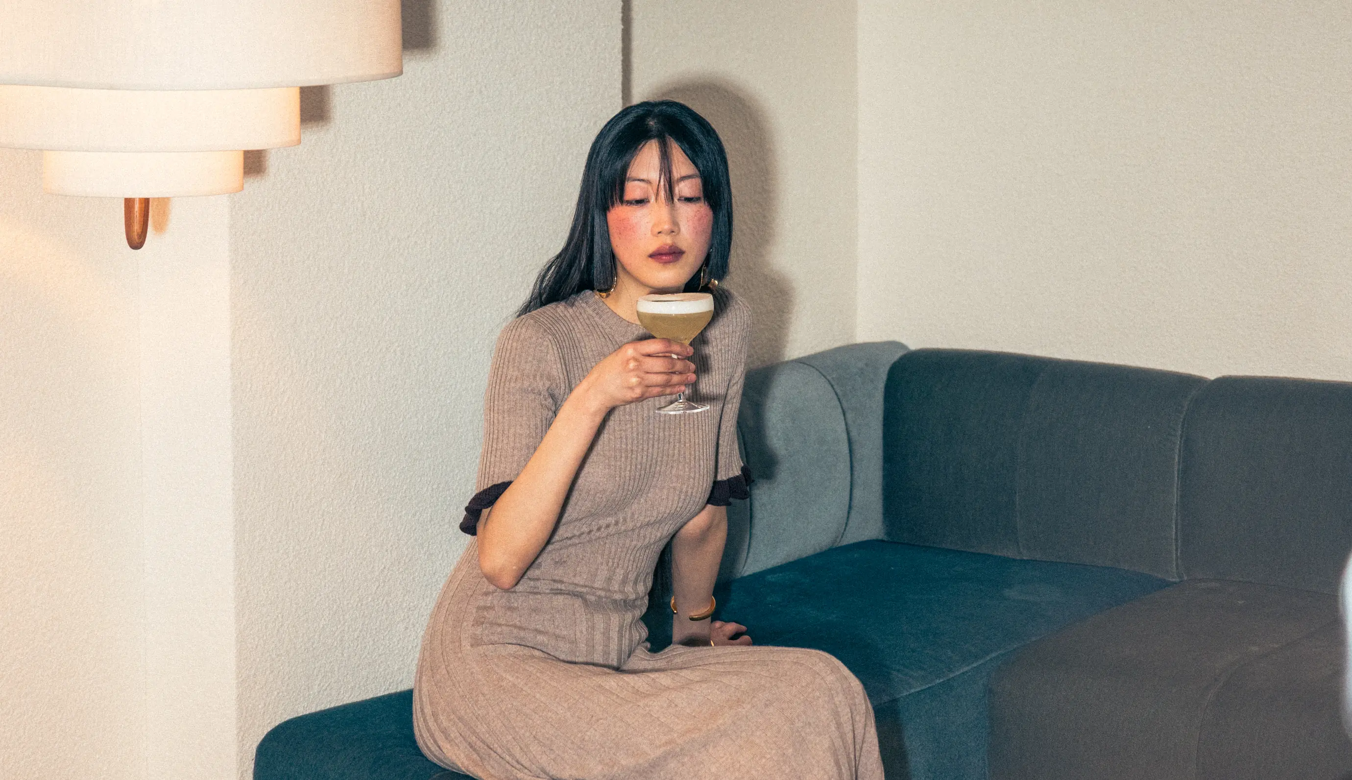 Elegant woman enjoying a cocktail in a cozy atmosphere, Experimental Group.