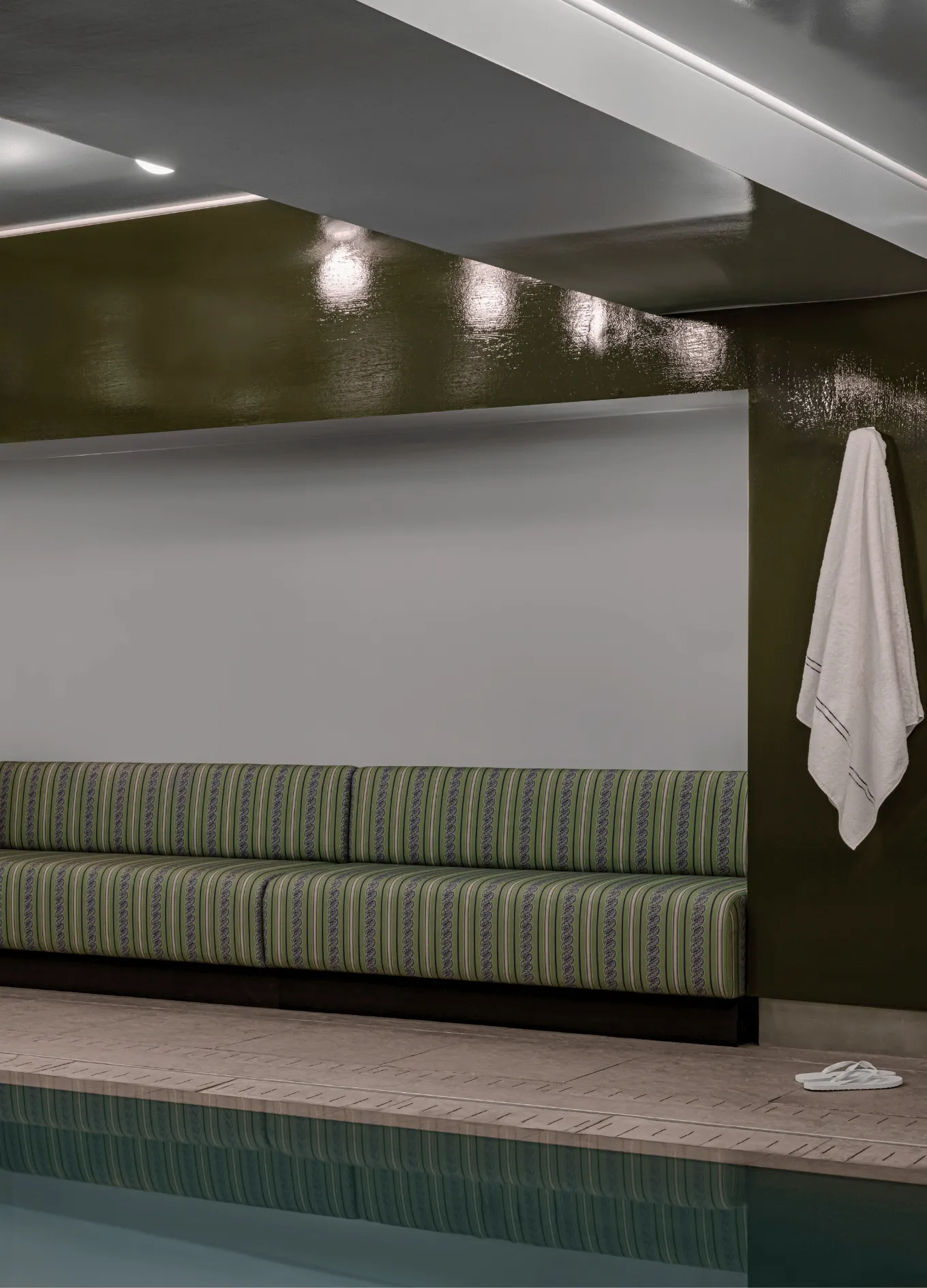 Indoor swimming pool with striped bench and white towel, Experimental Group.
