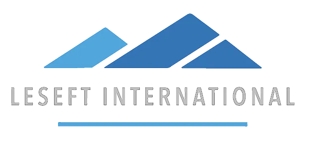 Logo with three blue parallelograms arranged to form a stylized roof above the text 'Lesefit International' and a horizontal blue line underneath.