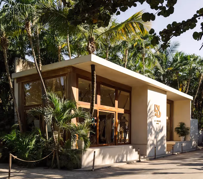 Exterior view of the luxury boutique at La Valise Tulum hotel surrounded by lush tropical jungle in Mexico.