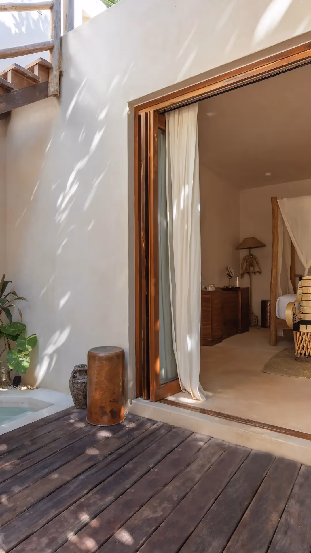Luxury suite at La Valise Tulum featuring a private plunge pool and seamless indoor-outdoor access to a canopy bed bedroom.