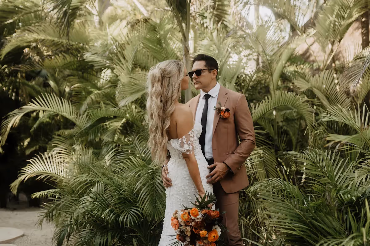Tropical wedding celebration featuring a bride and groom in the lush garden of La Valise Tulum Hotel.