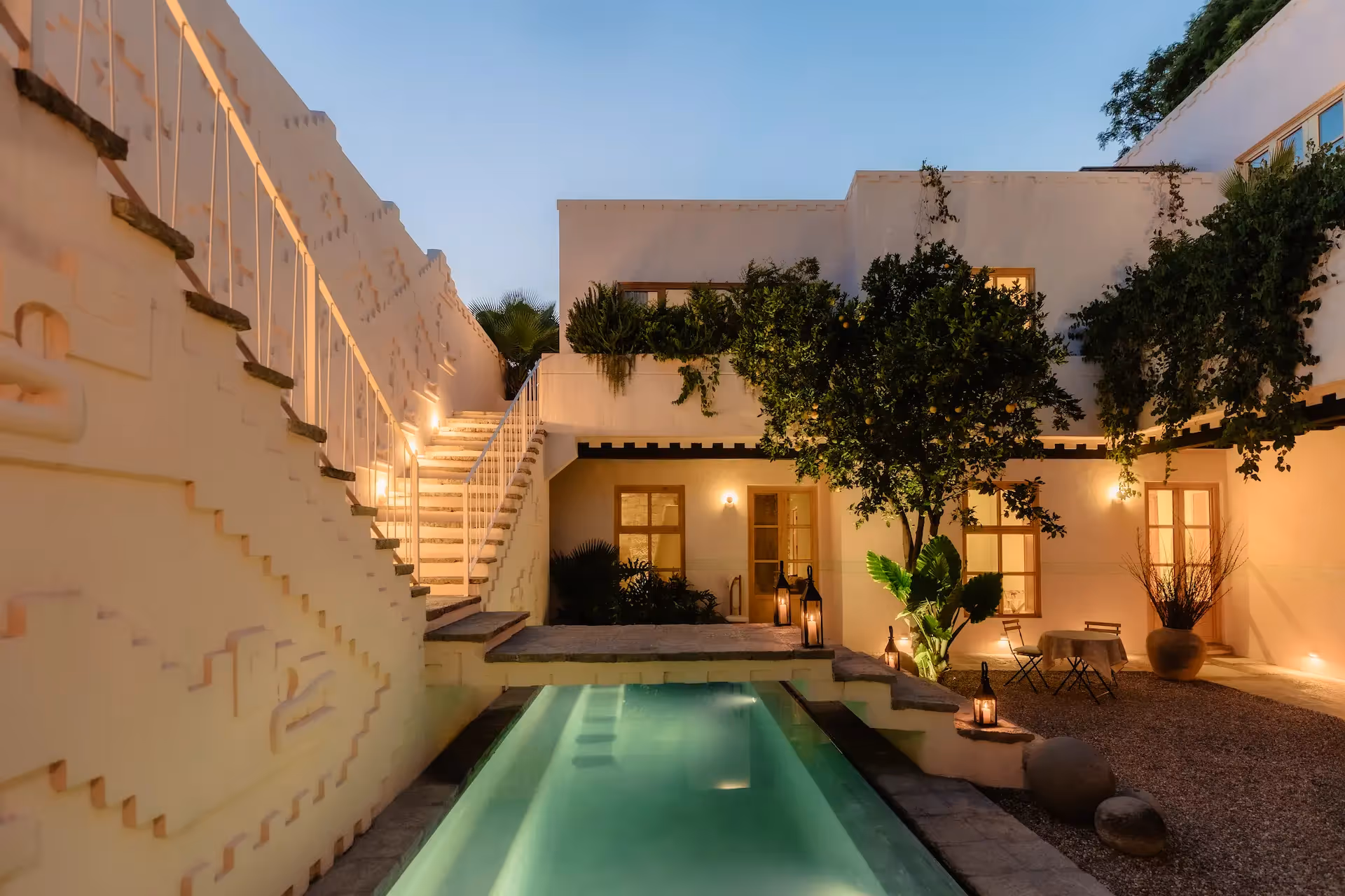 Private pool illuminated at dusk at La Valise Tulum Hotel, showcasing modern Mexican architecture and an intimate luxury atmosphere.
