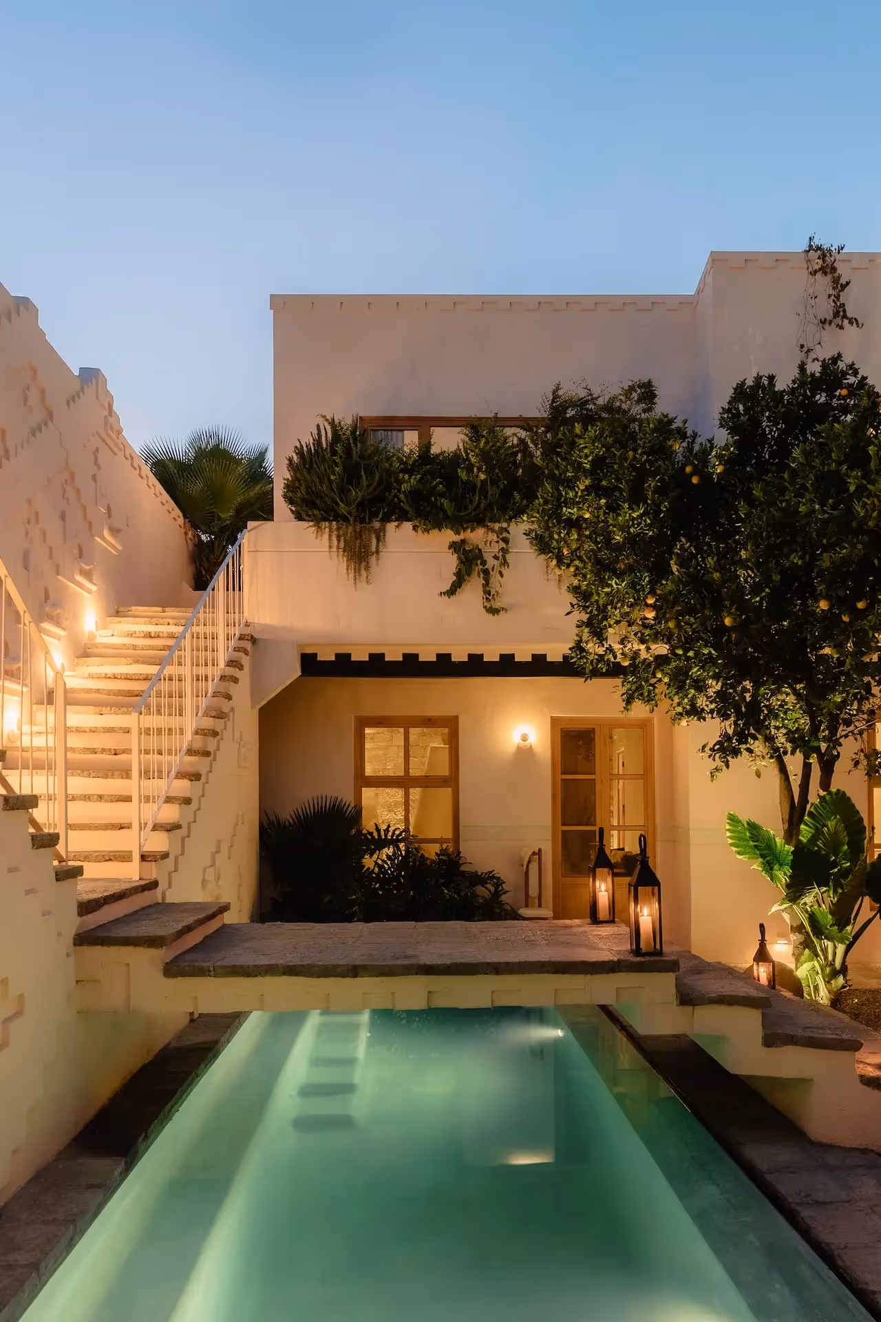 Aerial view of the white sand beach and tropical architecture of La Valise Tulum hotel nestled in the jungle.