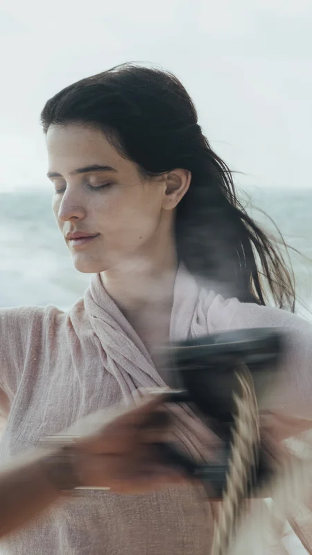 Woman practicing meditation facing the sea during a wellness session at La Valise Tulum Hotel.