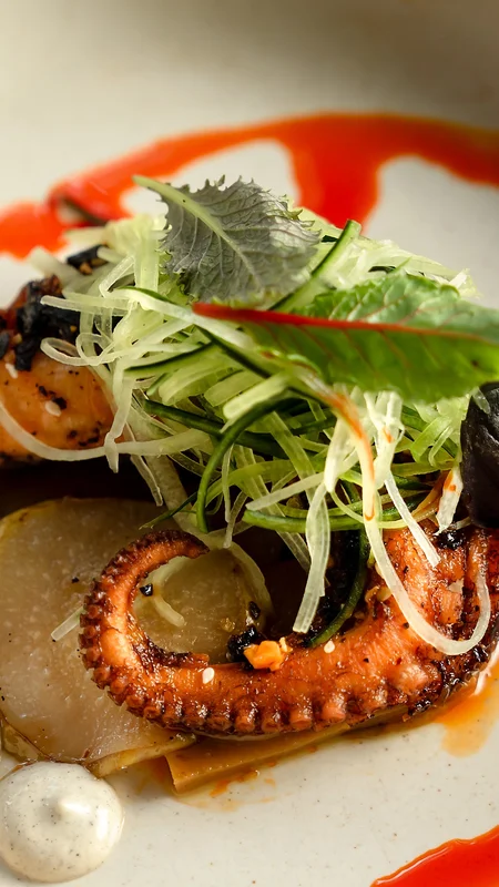Steaming gourmet dish served in a volcanic stone bowl at La Valise Tulum Hotel restaurant.