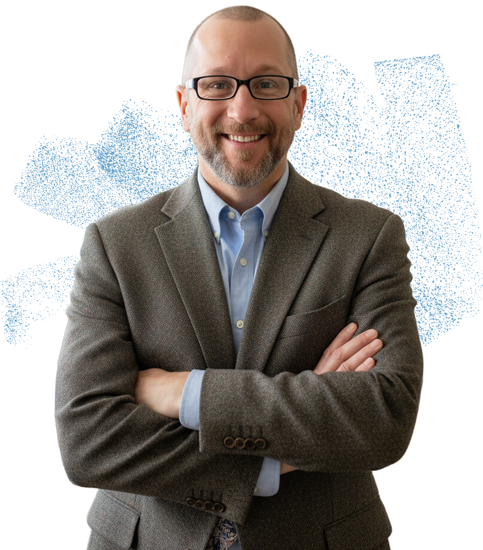 Smiling man with glasses, wearing a brown blazer and blue shirt, arms crossed.