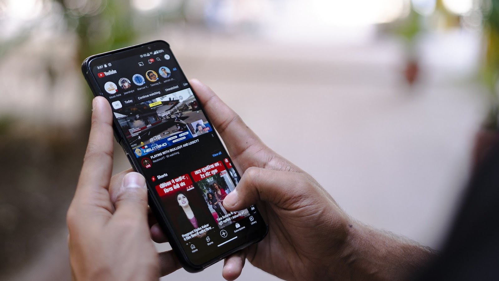 Person viewing YouTube on a cellphone
