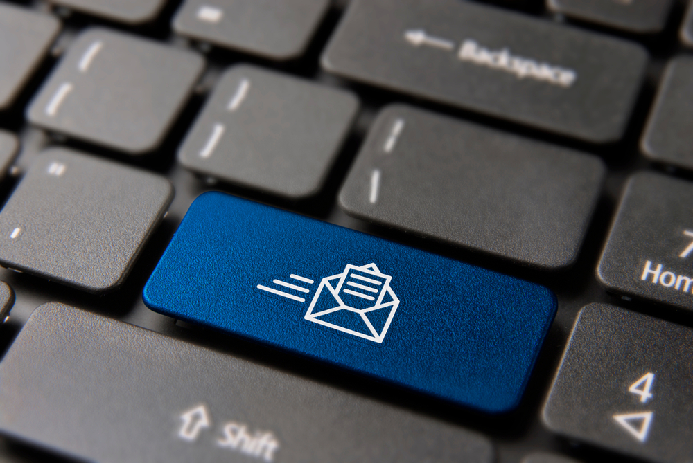Blue button with email icon within black computer keyboard