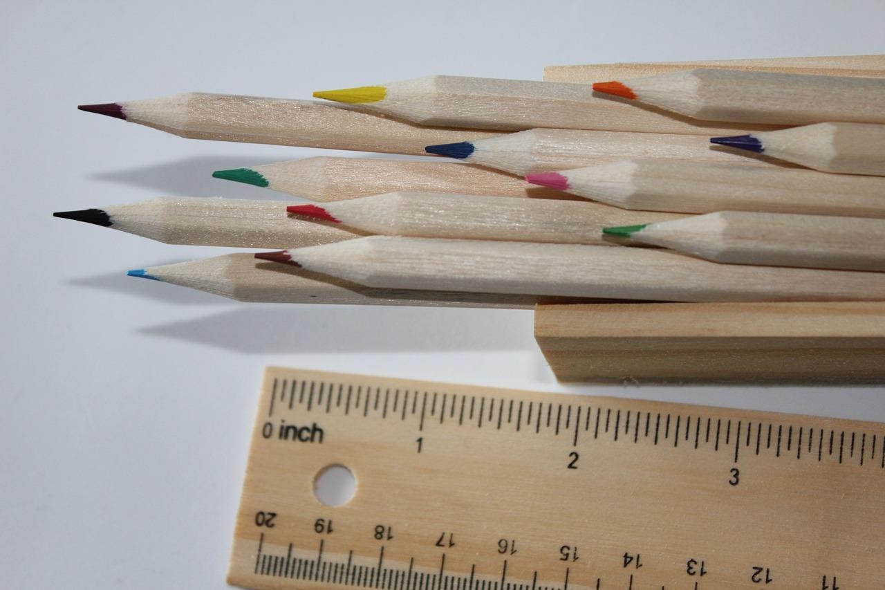 A picture of colored pencils and a wooden ruler