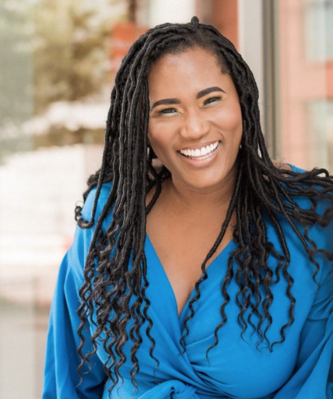 Image of photographer De Lisa Carol smiling and wearing a blue dress