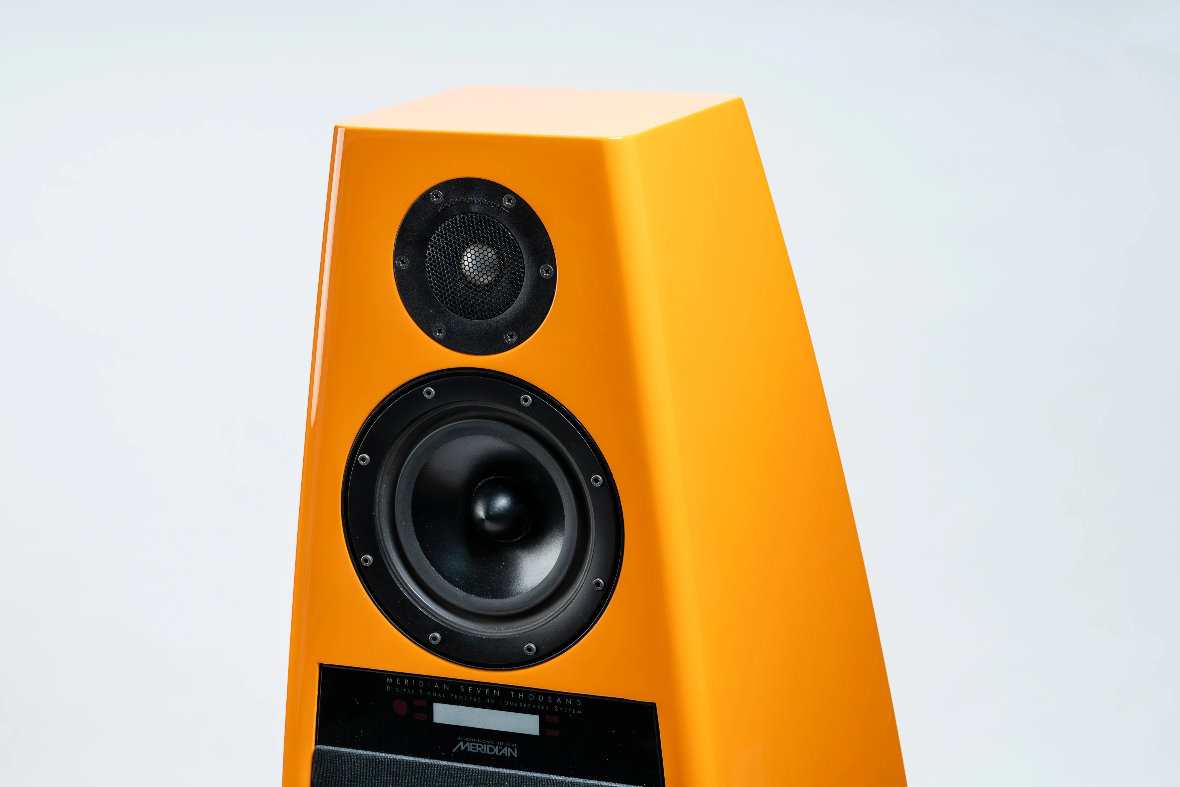 Bright orange Meridian Seven Thousand digital signal processing loudspeaker with two drivers and a black control panel.