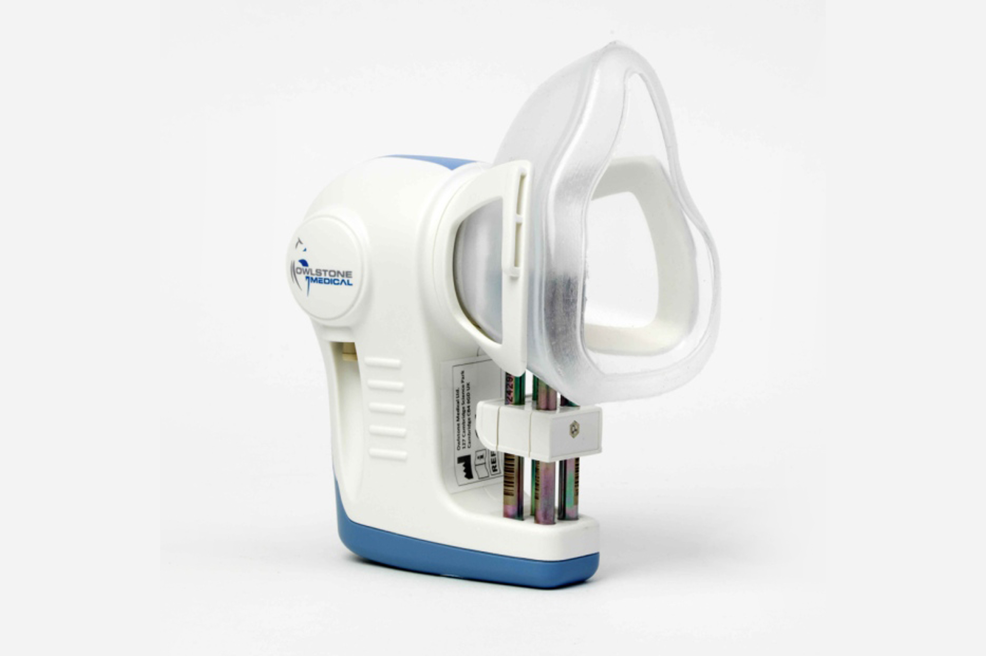 White and blue handheld medical device with a transparent mask, labeled Owlstone Medical.
