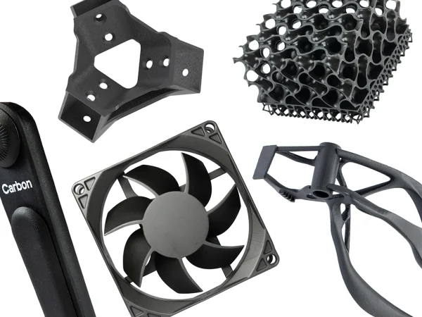 Various black 3D printed objects including a fan frame with blades, a honeycomb lattice structure, a triangular bracket, a clamp, and a handle marked Carbon.