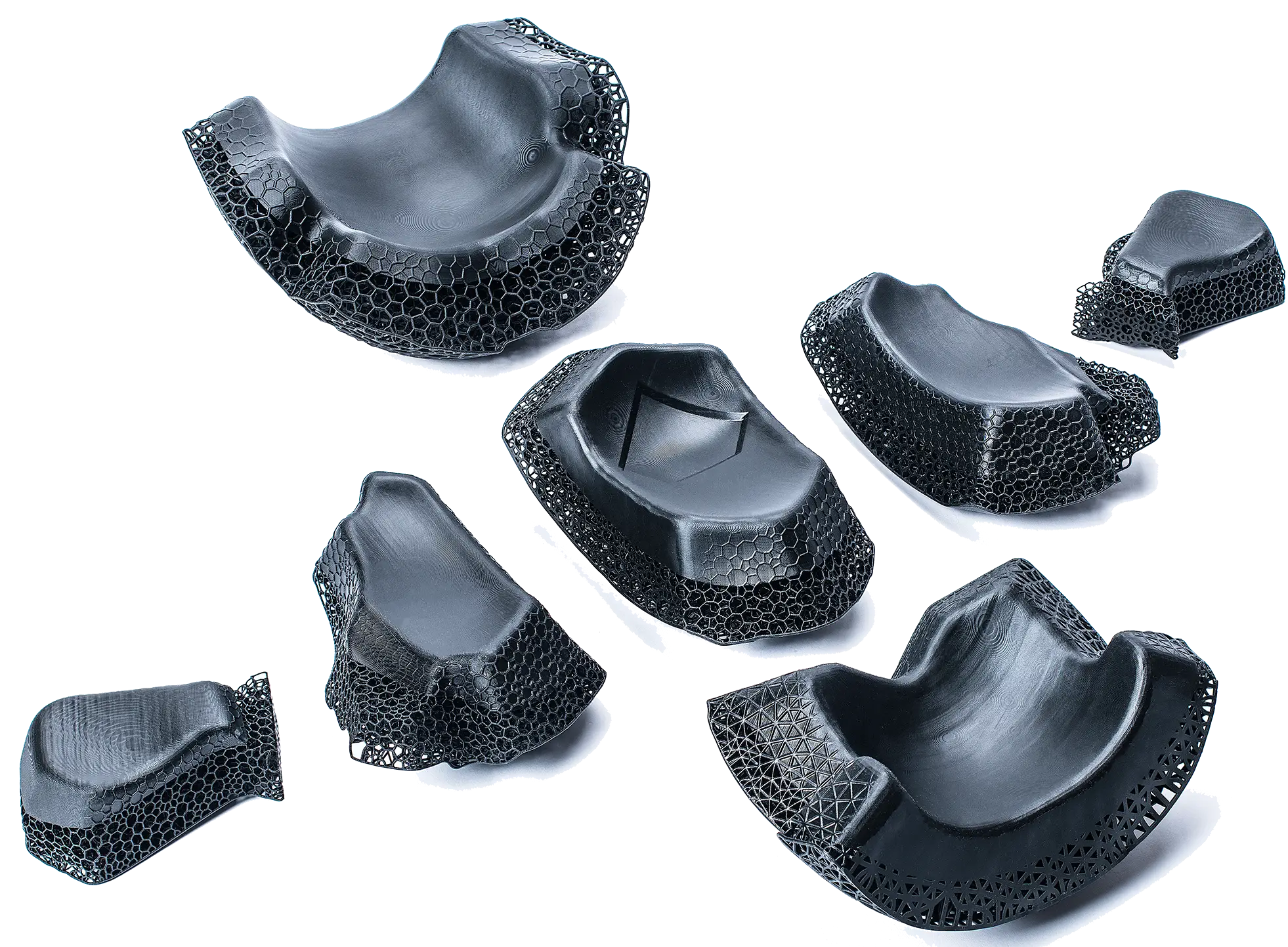 Seven black 3D-printed parts with honeycomb and lattice structures.