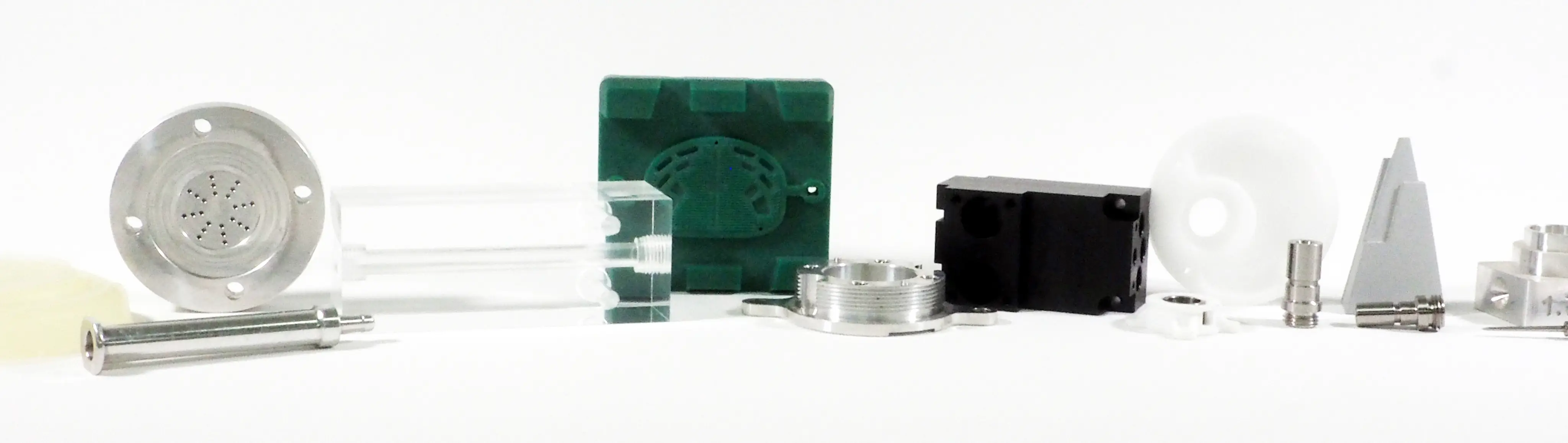 Various small mechanical and plastic parts arranged in a row on a white background.